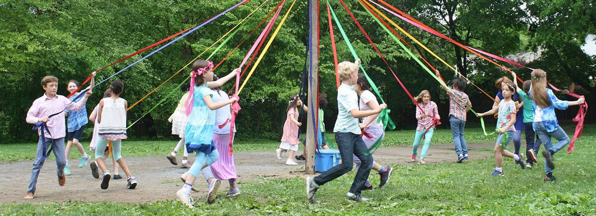 Kids dancing around a May Day pole